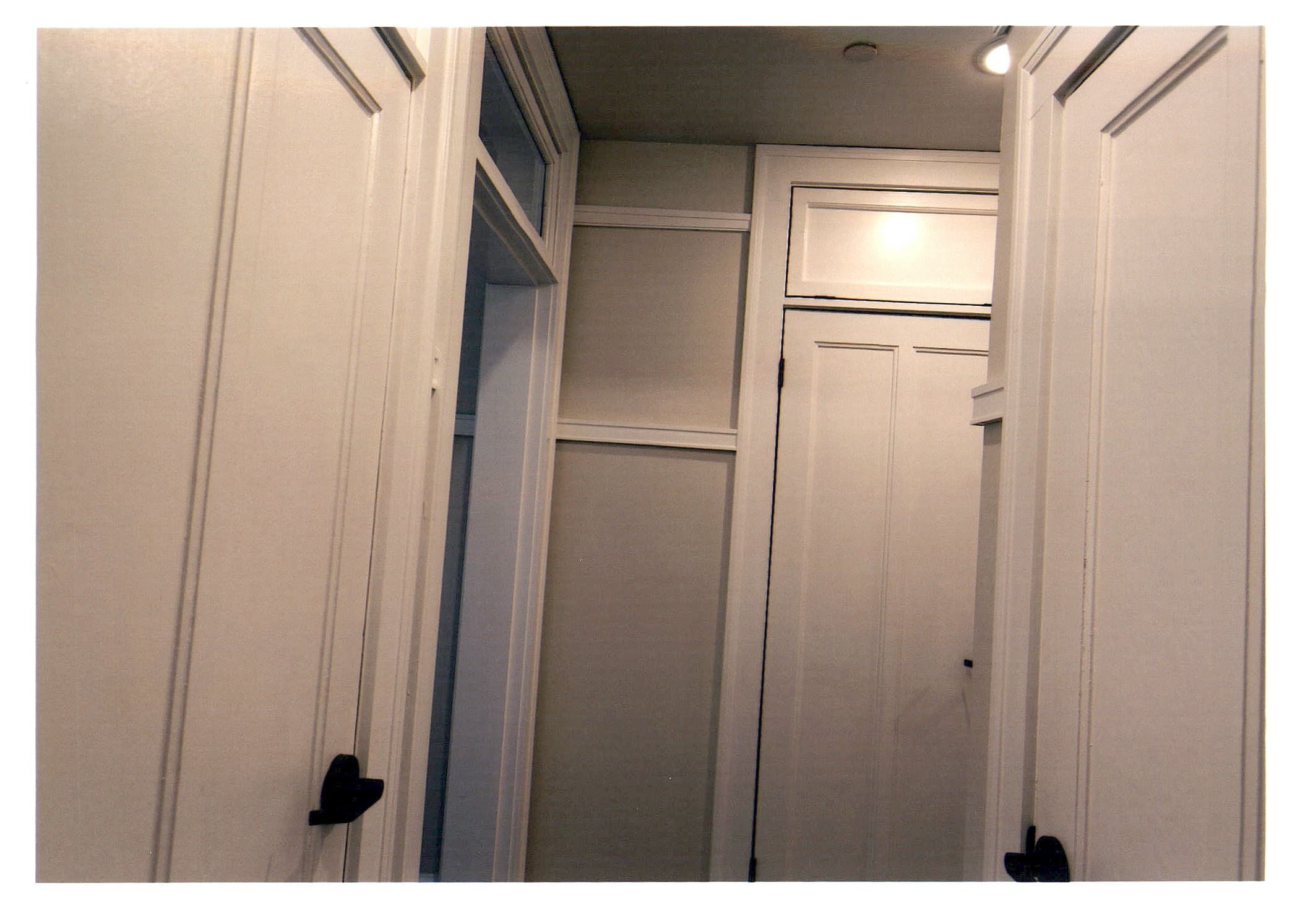 After: another view of the hallway showing more apartment entrances. 